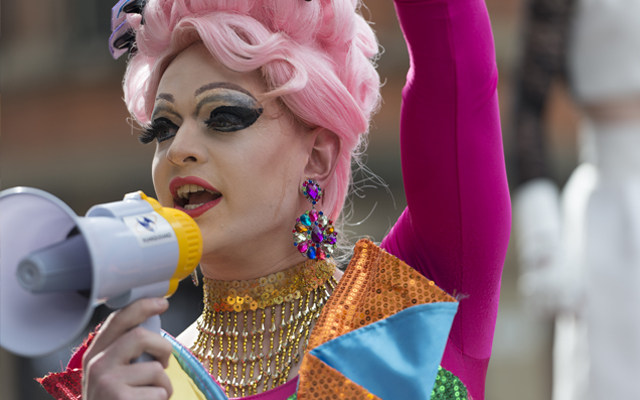 Seattle, Washington, USA- June 29, 2015: This image shows participants in the 2015 Seattle Pride Parade. The Pride Parade celebrates gay rights and attracts large crowds each year. These people are walking along the parade route.